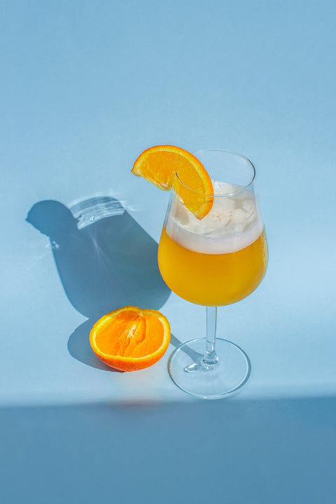 Nonalcoholic orange drink with blue background